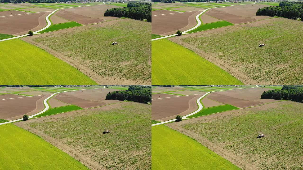 空中: 飞越拖拉机，为农村大片农田施肥