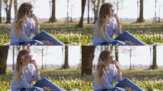 SLO MO年轻女子在春季公园放松