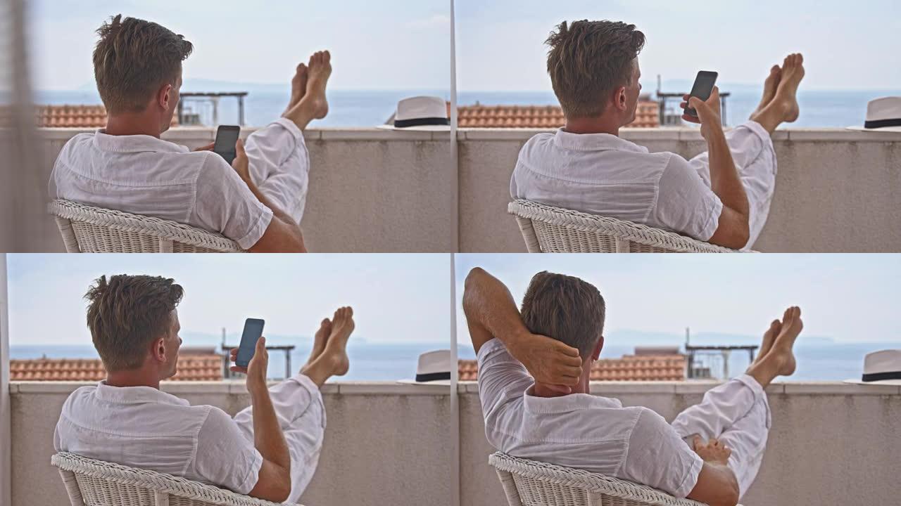 DS男子在海滨酒店使用智能手机