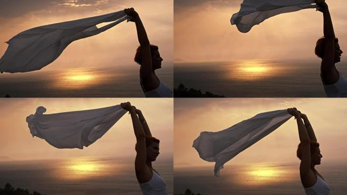 SLO MO女人在风中举起围巾