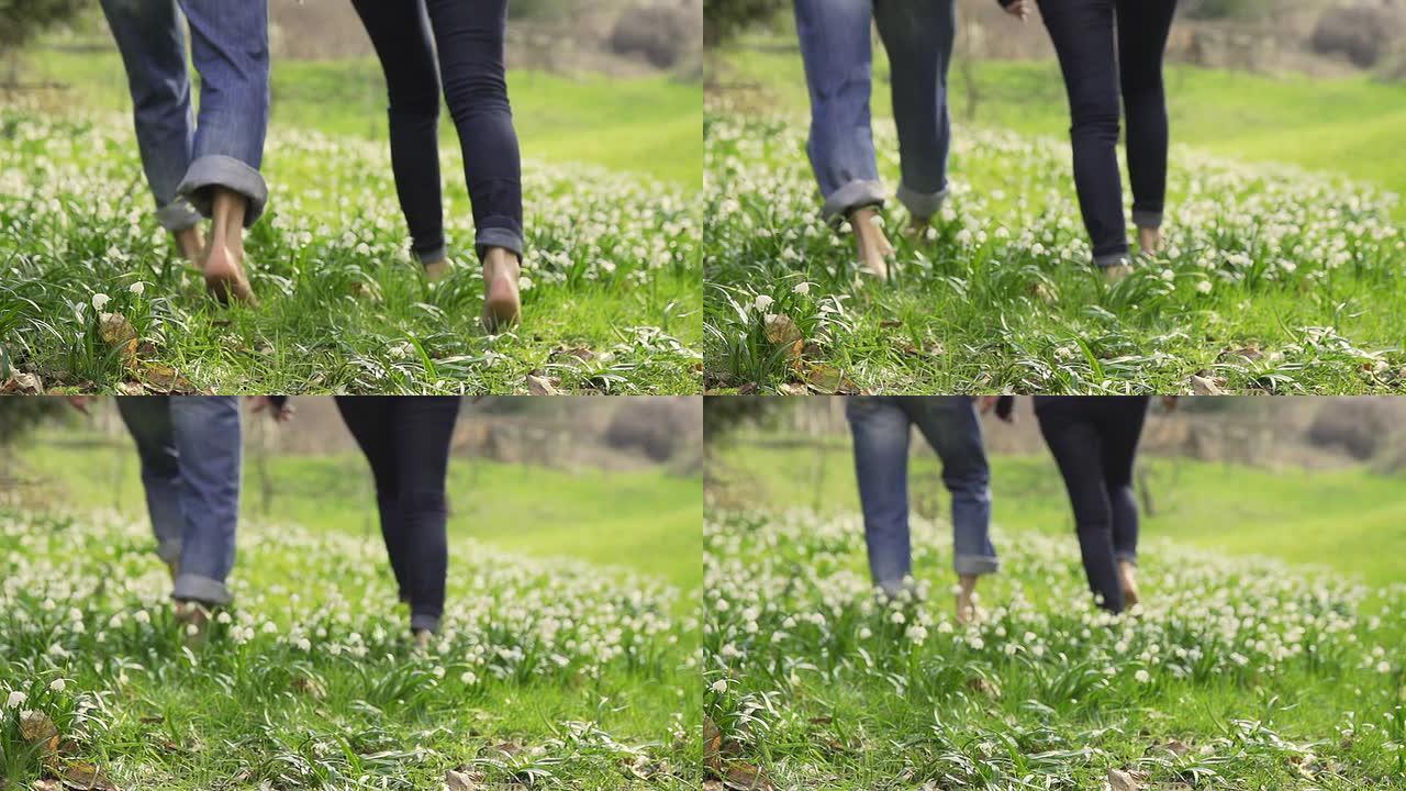 高清超慢动作: 情侣赤脚走在草地上