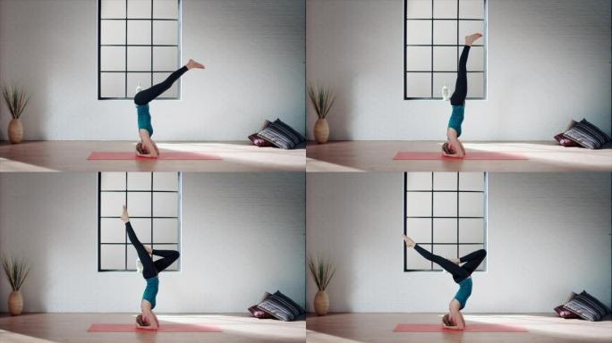 女人在健身房练习瑜伽 (倒立姿势)