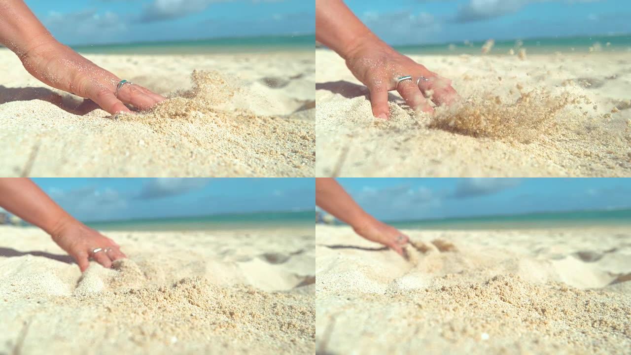慢动作: 无法辨认的女人用手指穿过滚烫的白沙。