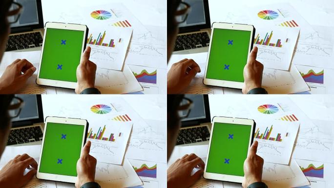 使用数字平板电脑，绿色屏幕拍摄商人的肩膀