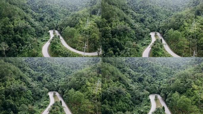 森林中的道路和汽车行驶的鸟瞰图