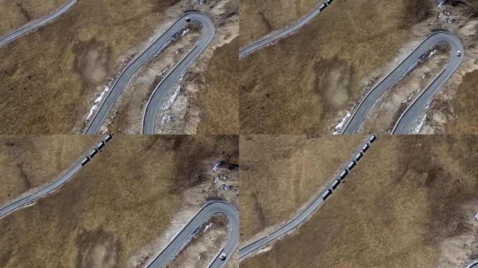 4k高原蜿蜒道路上汽车行驶的鸟瞰图