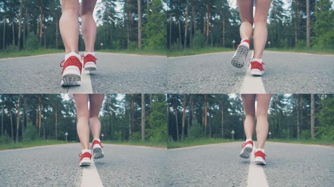 女性脚踝开始慢动作跑步的特写。女运动员慢跑。