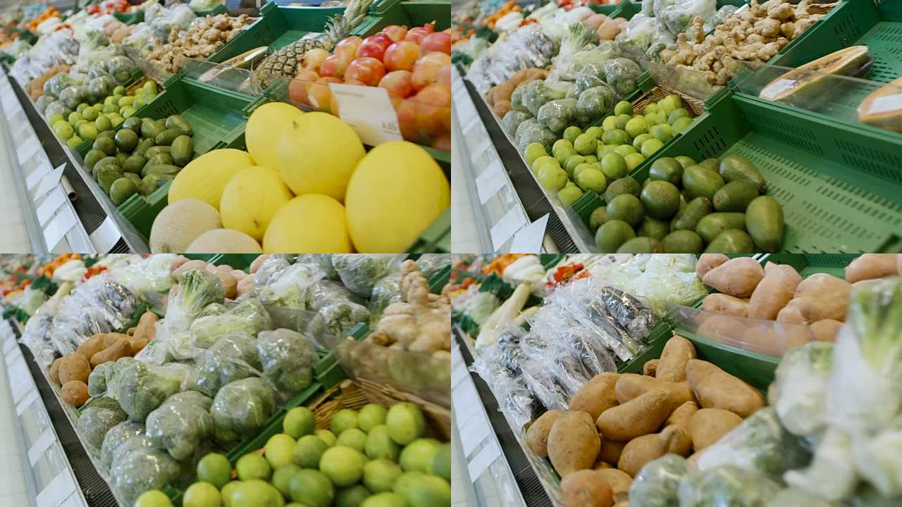 在超市: 商店新鲜农产品区的滑行镜头。农贸市场上出售的异国水果和有机蔬菜。