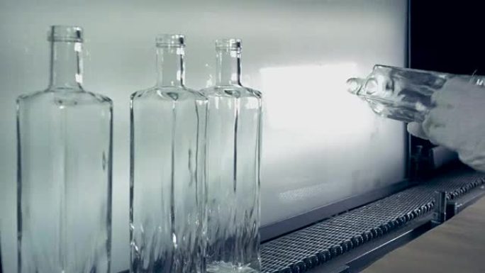 Quality control of bottles at a plant, close up.