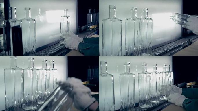 Quality control of bottles at a plant, close up.