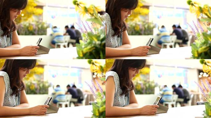 4K: 年轻女子在咖啡店使用数字平板电脑