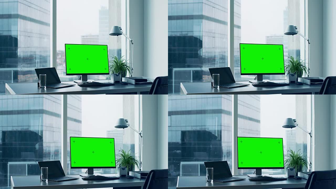 办公桌上的滑动镜头，上面站着绿色的模拟屏幕个人计算机。现代时尚的房间，可以看到大城市商业区的景色。