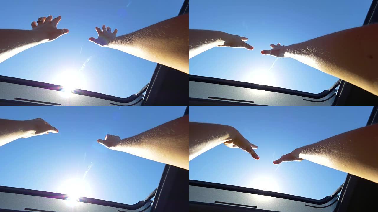 POV: 开朗的女人，带环的手臂伸出汽车的天窗