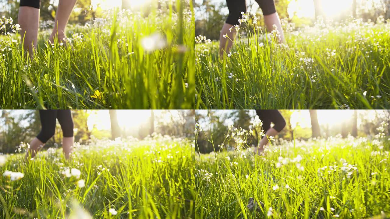 SLO MO女人在春天的草地上赤脚行走