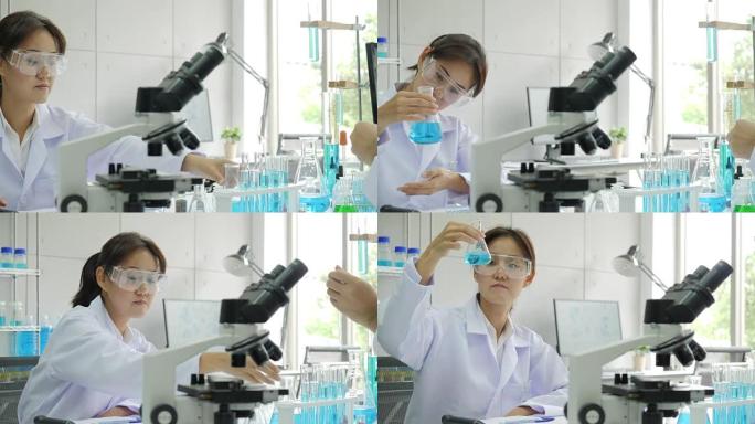 亚洲女性医学研究科学家在实验室中通过显微镜观察