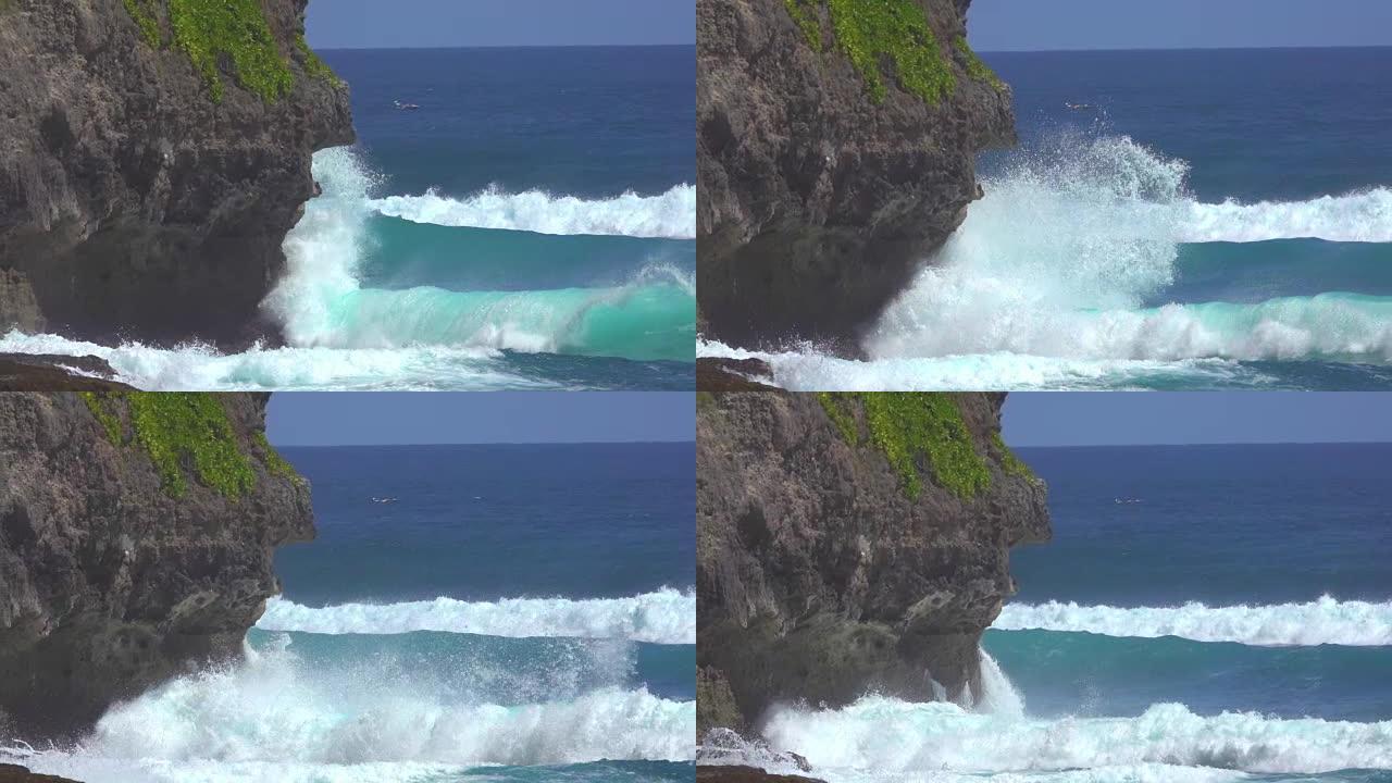慢动作: 美丽的泡沫绿松石海浪撞向黑色悬崖。