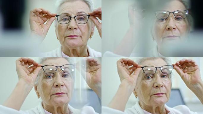 资深女性在眼科诊所试戴眼镜