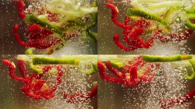 切碎的红色，绿色和黄色甜椒掉入沸水中