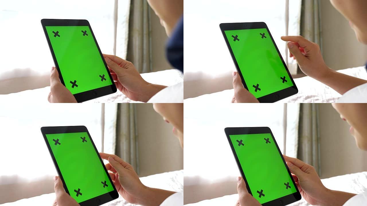 使用绿屏平板手机的女性