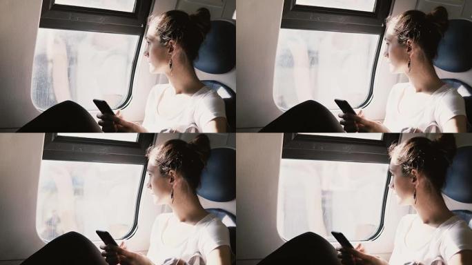 美丽的和平的欧洲女孩使用智能手机应用程序在火车上旅行，键入消息，看着窗户