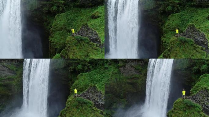 冒险旅行摄影师拍摄瀑布站在悬崖边缘的照片
