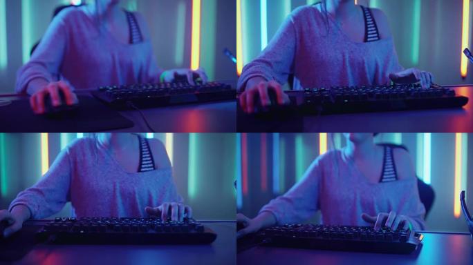使用键盘在视频游戏中玩的女孩游戏手的特写镜头。女黑客闯入系统。带凉爽霓虹灯的背景。