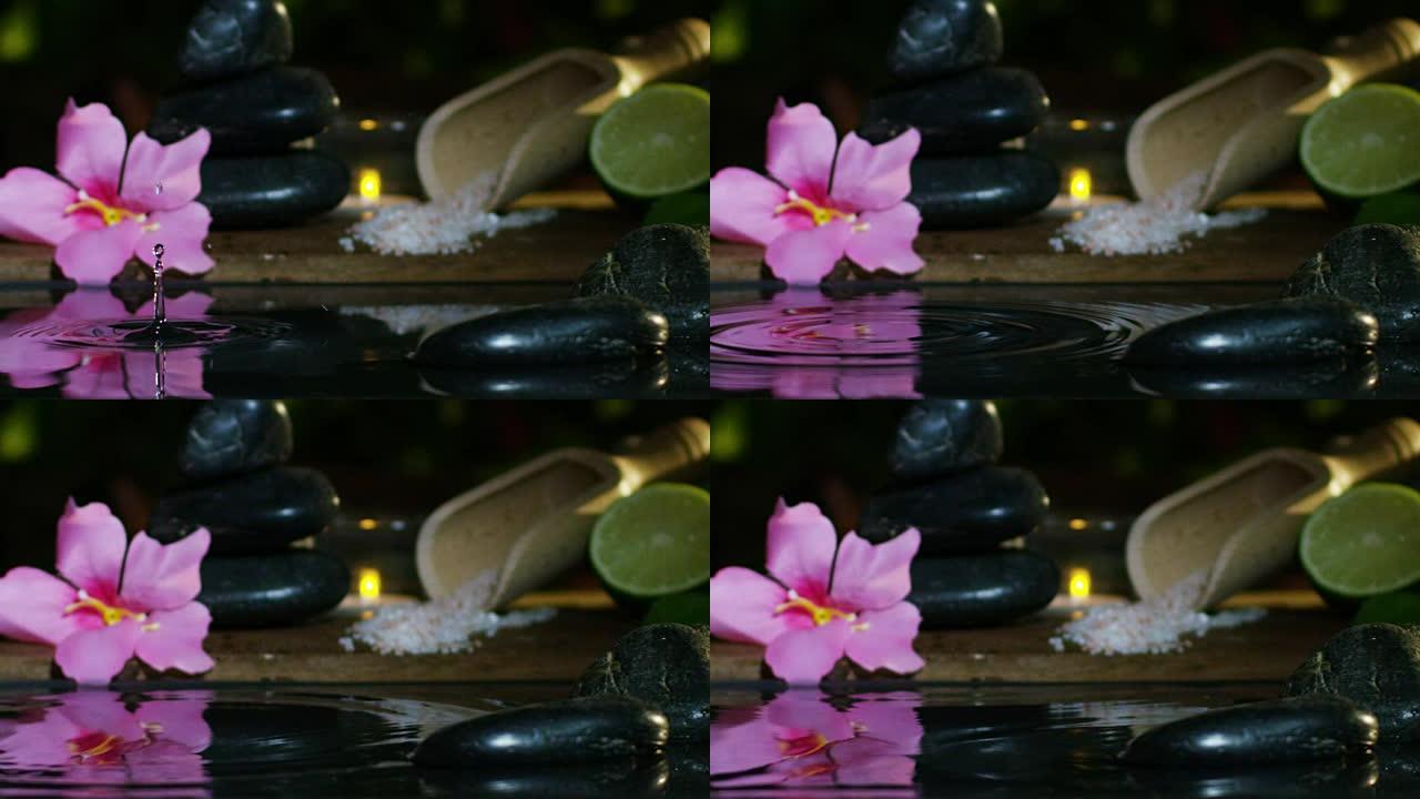美丽的水和蜡烛水疗和健康组合以极端慢动作拍摄。放松和冥想的概念。水