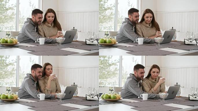快乐的情侣聊天看着笔记本电脑