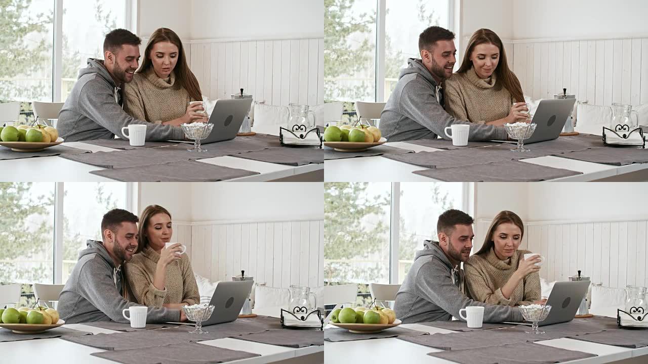 快乐的情侣聊天看着笔记本电脑