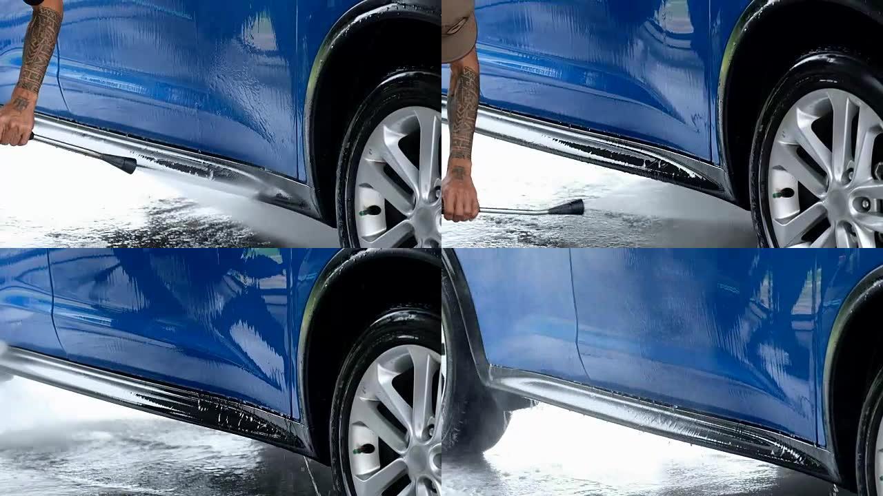 慢动作，用蓝色海绵和高压清洗关闭男子手清洁车