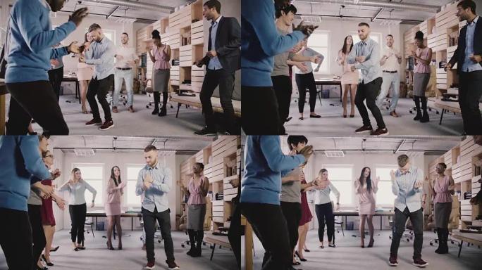 年轻的欧洲商人在办公室聚会上与同事围成一圈跳舞，庆祝职业晋升慢动作