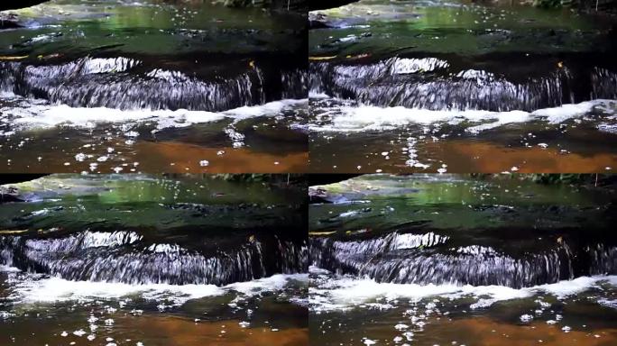 柬埔寨带有气泡的森林小瀑布的慢动作FHD镜头，自然与环境概念
