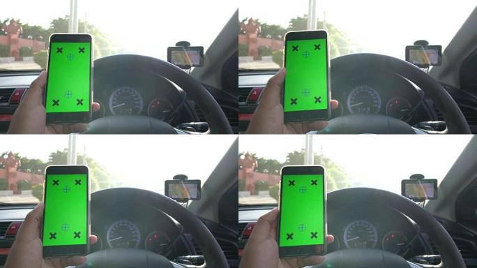 商人在带有GPS，绿屏的汽车中使用智能手机
