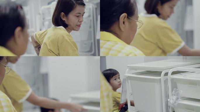 一个亚洲家庭在一家家具店看一个橱柜的零售展示，玩得很开心