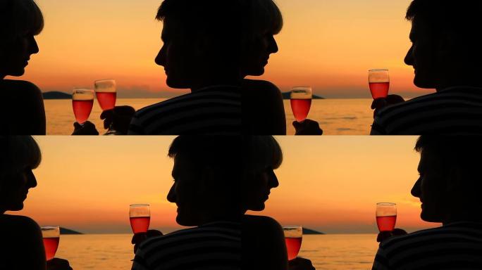 高清：情侣在日落时举杯庆祝