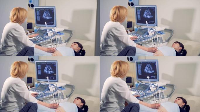 医生对孕妇进行超声波检查。