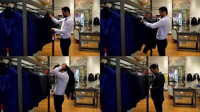 年轻人在正装商店里看着一件夹克，然后试穿
