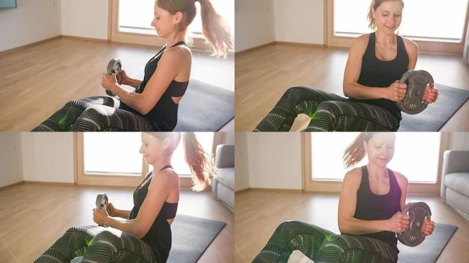 专注的女性正在做加权的俄罗斯扭转练习来锻炼腹部肌肉