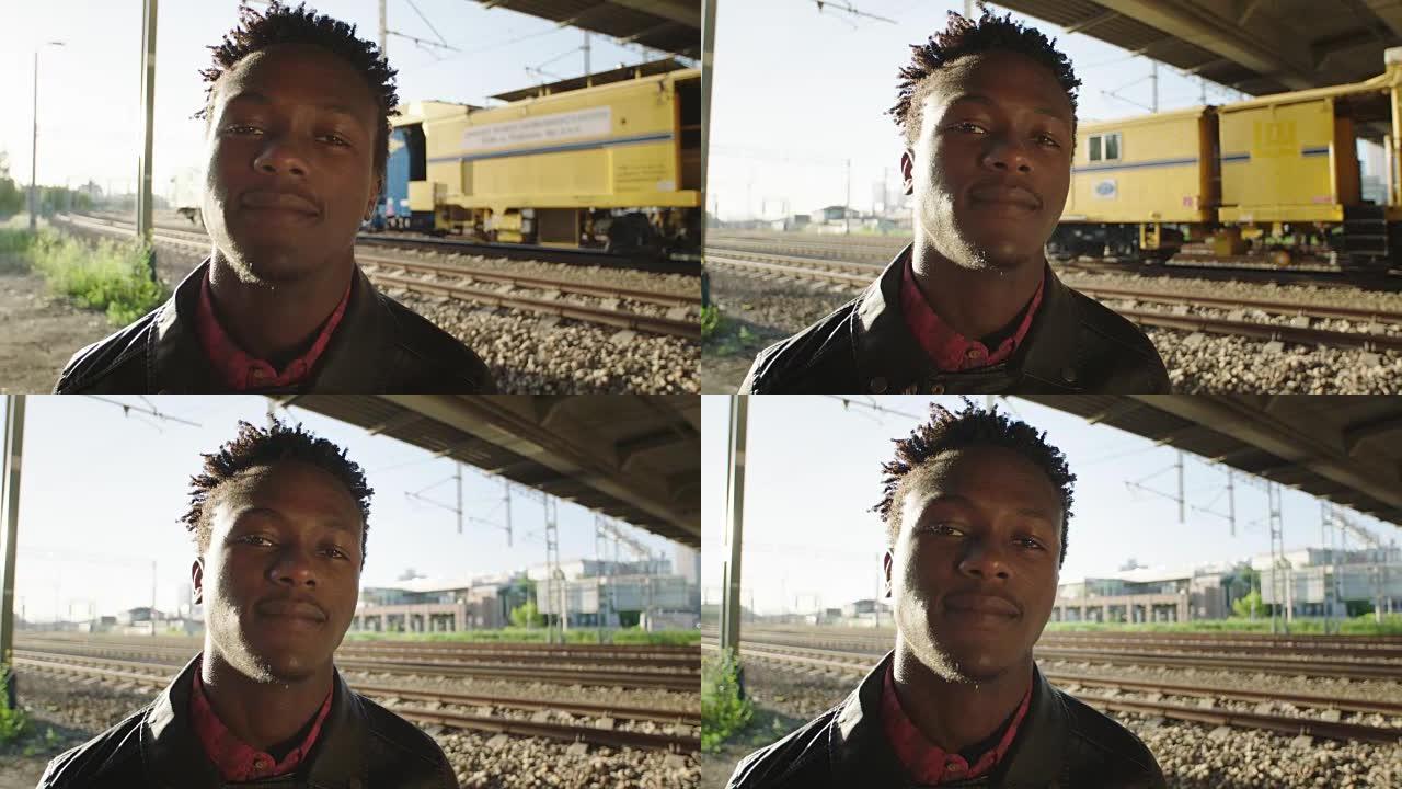 站在铁路卡车上的非洲男子肖像。