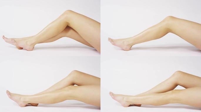 在腿上涂霜的女人女人涂抹奶油护肤化妆品