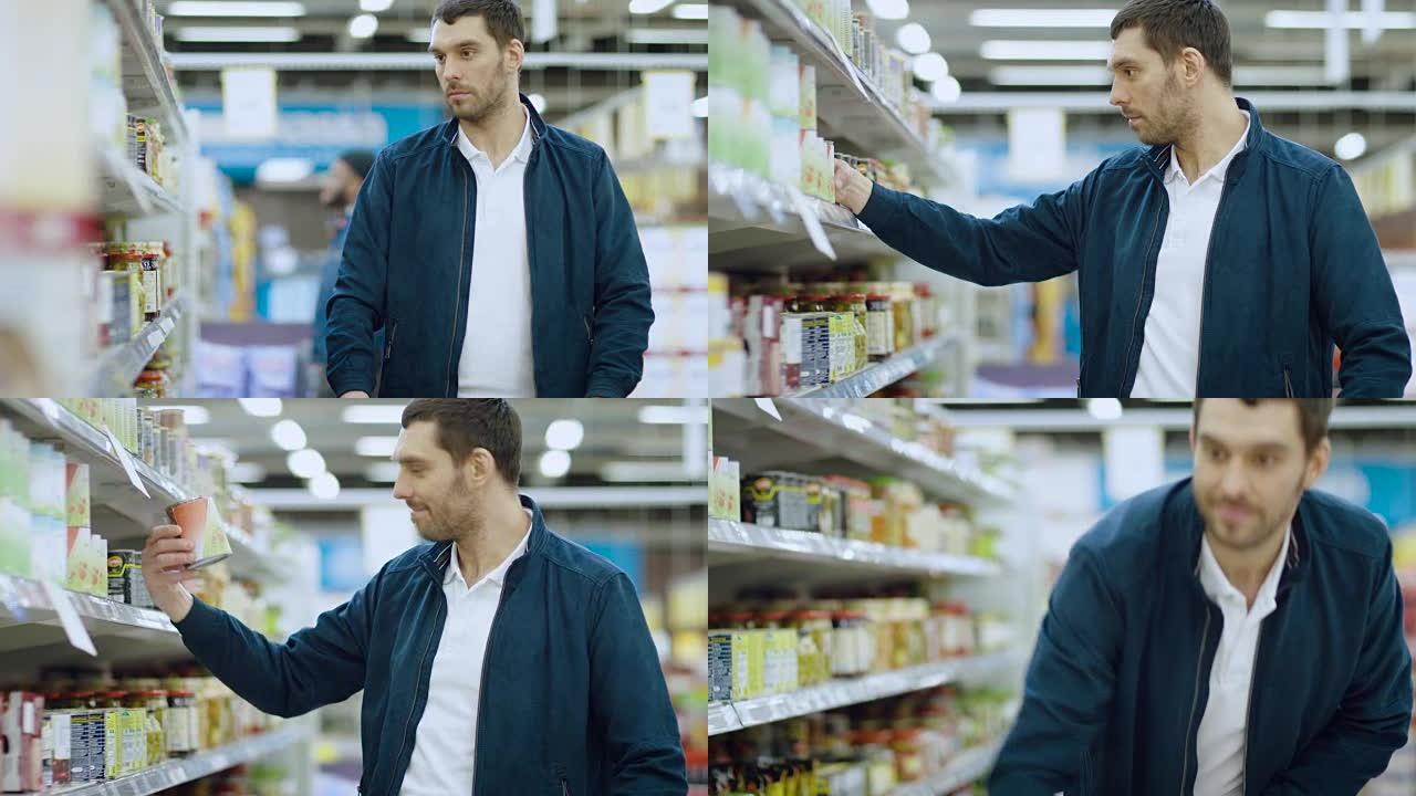 在超市:英俊的男人浏览货架上的罐头商品，把锡罐放进他的购物车，继续他的购物清单走过不同的部分。