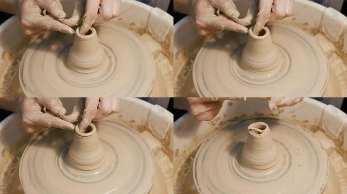 人的手在陶工的轮子上制作粘土器皿