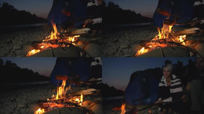 高清慢动作：情侣在篝火上烤肉