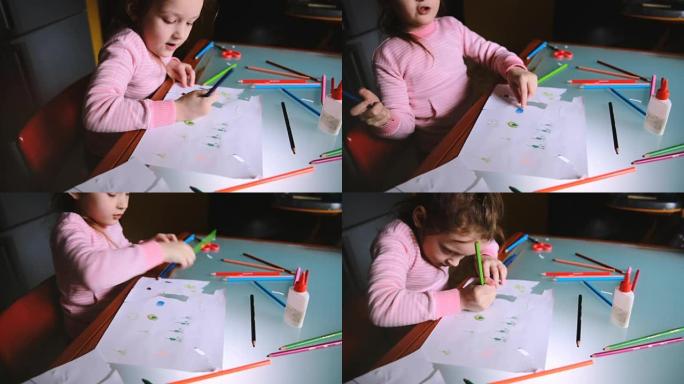 高角度相机在桌上用彩色铅笔画粉色毛衣画的高加索小女孩身上滑动