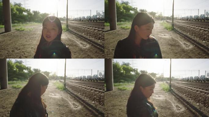 亚洲年轻女子独自在铁路上。