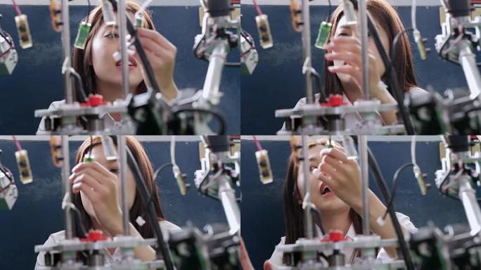 青少年为她的学校机器人俱乐部项目在一个功能齐全的可编程机器人上工作。创意设计师在车间测试机器人原型。
