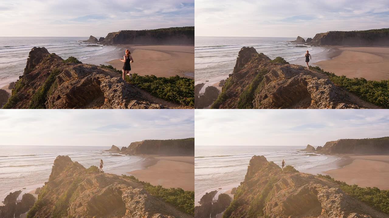 年轻的女运动员在海边的岩石地形上奔跑