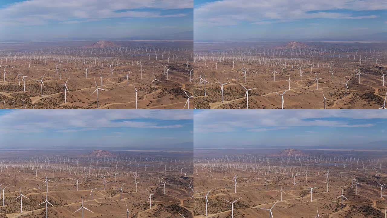 从上方俯视创造清洁可再生能源的巨型风力涡轮机场的鸟瞰图