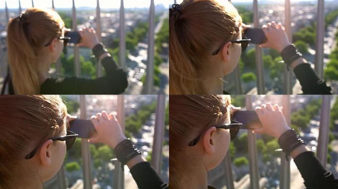 女人通过从凯旋门顶部拍摄巴黎的照片来创造回忆