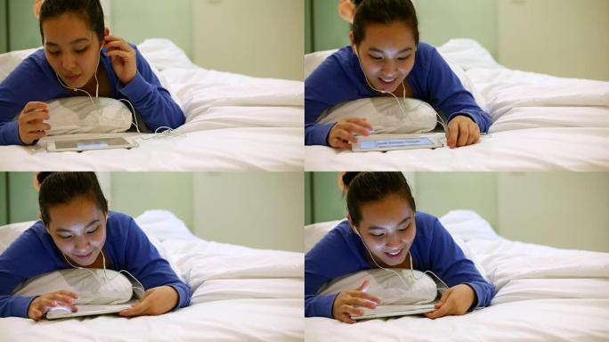 恋爱中的亚洲年轻女子在床上听音乐，4k(UHD)